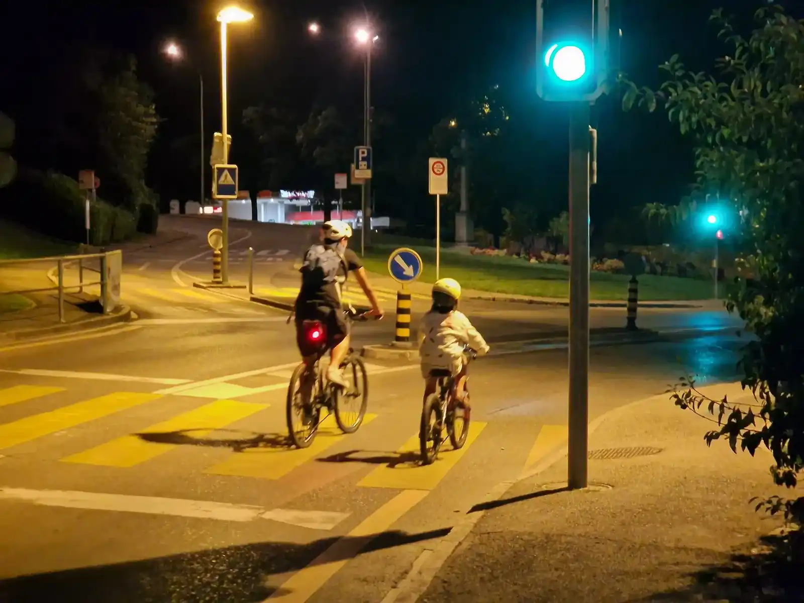 father-daughter duo riding bikes at night
