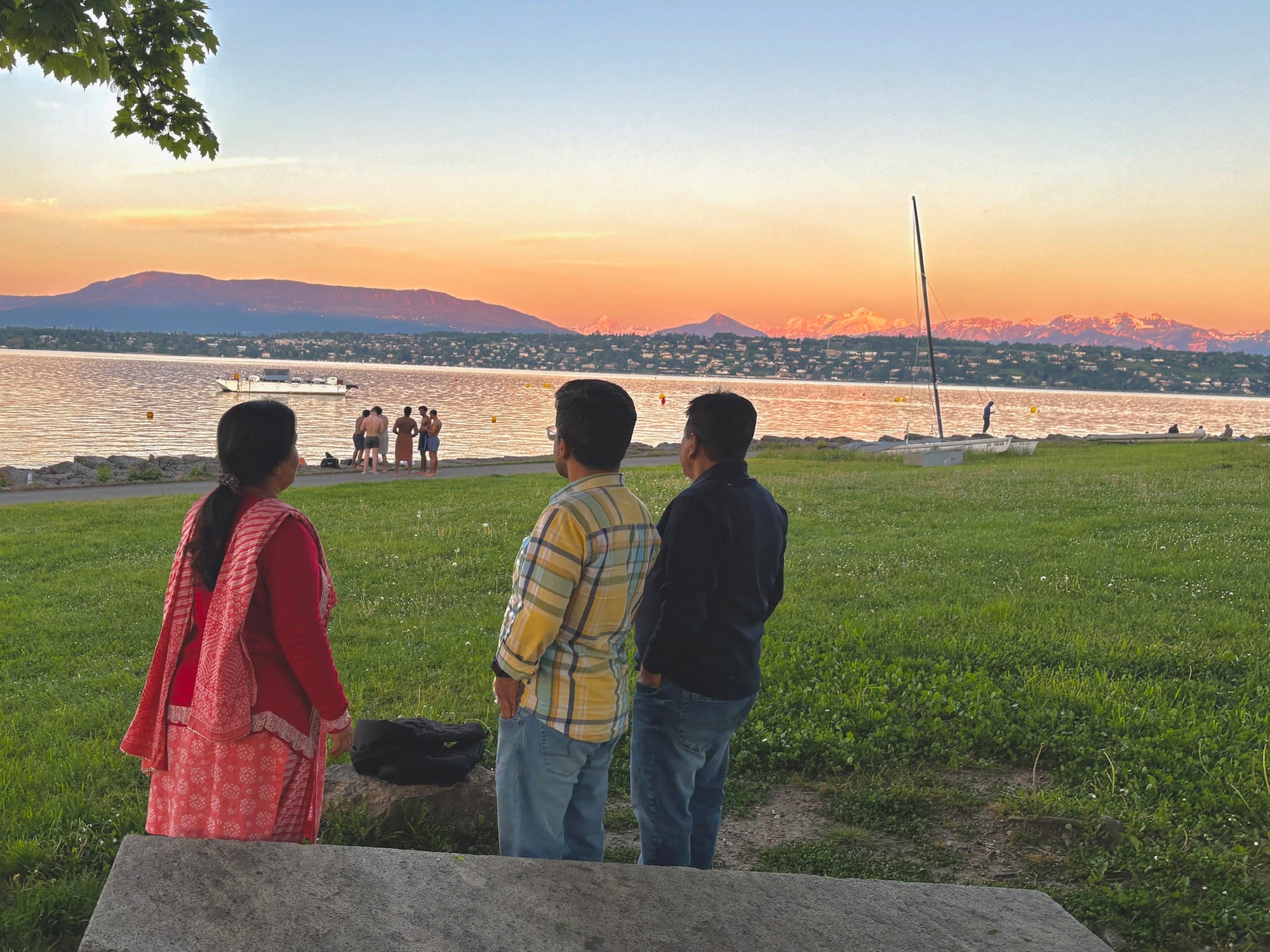 Three persons staring at sunset