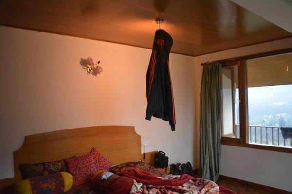 Jacket hung over a lamp in a room